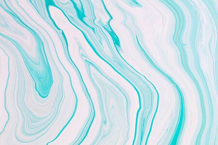Fluid art texture. Abstract backdrop with mixing paint effect. Liquid acrylic picture that flows and splashes. Mixed paints for background or poster. Mint and white overflowing colorsの写真素材