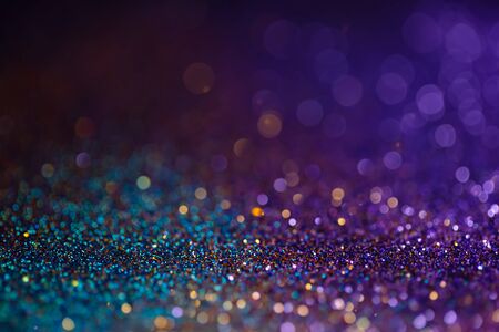 Decoration bokeh lights background, abstract sparkle backdrop with circles,modern design overlay with sparkling glimmers. Blue, purple and golden backdrop glittering sparks with blur effectの写真素材