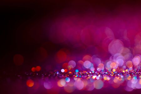 Decoration twinkle lights background, abstract shiny backdrop with circles,modern design wallpaper with sparkling glimmers. Purple, blue, pink and black backdrop glittering sparks with glow effectの写真素材