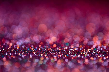 Decoration bokeh lights background, abstract glowing backdrop with circles,modern design overlay with sparkling glimmers. Purple, pink and golden backdrop glittering sparks with blur effectの写真素材