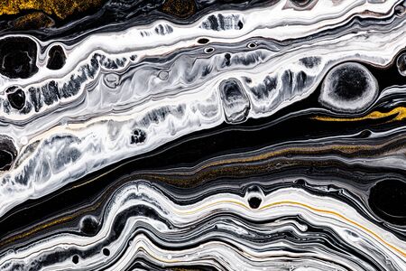 Fluid art texture. Background with abstract mixing paint effect. Liquid acrylic picture with flows and splashes. Mixed paints for website background. Golden, black and white overflowing colorsの写真素材