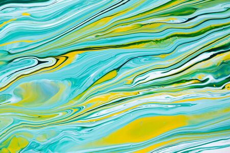 Fluid art texture. Abstract background with iridescent paint effect. Liquid acrylic picture with flows and splashes. Mixed paints for interior poster. Blue, yellow and green overflowing colorsの写真素材