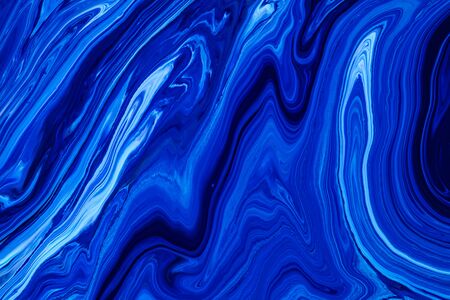 Fluid art texture. Backdrop with abstract swirling paint effect. Liquid acrylic artwork with flows and splashes. Classic blue color of the year 2020. Blue, white and indigo overflowing colorsの写真素材
