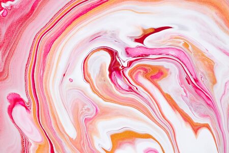 Fluid art texture. Background with abstract swirling paint effect. Liquid acrylic artwork with chaotic mixed paints. Can be used for posters or wallpapers. Pink, coral and golden overflowing colorsの写真素材