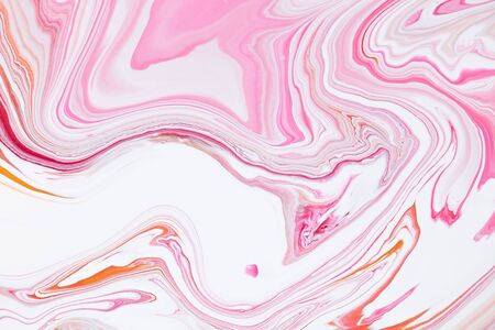 Fluid art texture. Abstract backdrop with iridescent paint effect. Liquid acrylic picture with flows and splashes. Mixed paints for background or poster. Pink, coral and golden overflowing colorsの写真素材