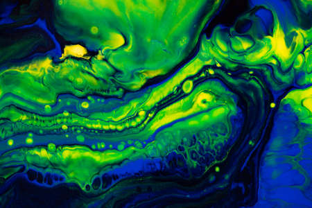 Fluid art texture. Backdrop with abstract mixing paint effect. Liquid acrylic artwork with flows and splashes. Mixed paints for baner or wallpaper. Green, blue and yellow overflowing colorsの写真素材