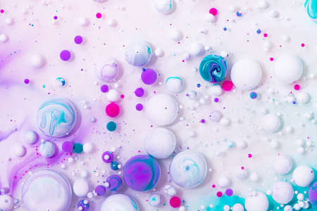 Fluid art texture. Abstract backdrop with iridescent paint effect. Liquid acrylic artwork that flowing bubbles. Mixed paints for website background. White, purple and pink overflowing colorsの写真素材