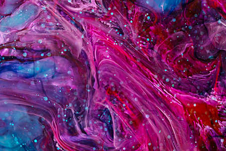 Resin art paint with pink, blue and red colors. Fluid backdrop with splashes and swirls. Abstract frozen artwork with splatter inks. Bright colors mixes on macrophotography pictureの写真素材