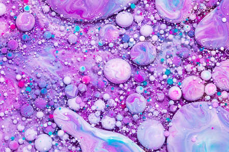 Fluid art texture. Background with abstract swirling paint effect. Liquid acrylic artwork that flowing bubbles. Mixed paints for background or poster. Purple, pink, blue and white overflowing colorsの写真素材