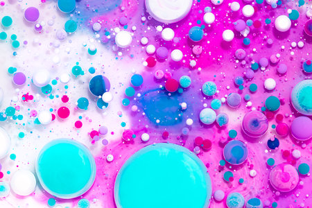 Fluid art texture. Background with abstract iridescent paint effect. Liquid acrylic artwork that flowing bubbles. Mixed paints for website background. Pink, aquamarine and white overflowing colorsの写真素材