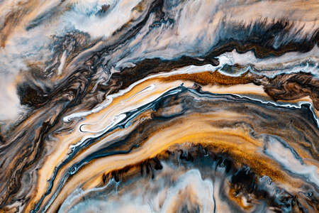 Fluid art texture. Abstract backdrop with iridescent paint effect. Liquid acrylic artwork with beautiful mixed paints. Can be used for interior poster. Brown, golden and navy blue overflowing colorsの写真素材