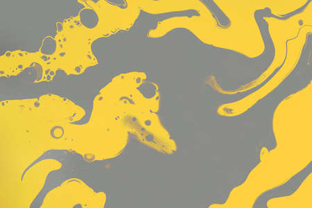 Fluid art texture. Background with abstract swirling paint effect. Liquid acrylic picture with colorful mixed paints. Can be used for background or poster. Gray and yellow overflowing colorsの写真素材