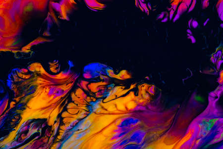 Fluid art texture. Background with abstract swirling paint effect. Liquid acrylic artwork with chaotic mixed paints. Can be used for posters or wallpapers. Orange, black and blue overflowing colorsの写真素材