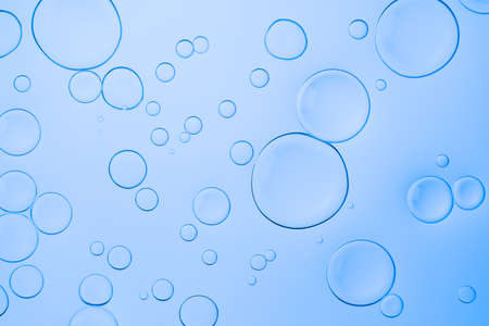 Vivid neon background with bubbles. Colorful abstract backdrop with bright gradients on blobs. Blue overflowing colorの写真素材