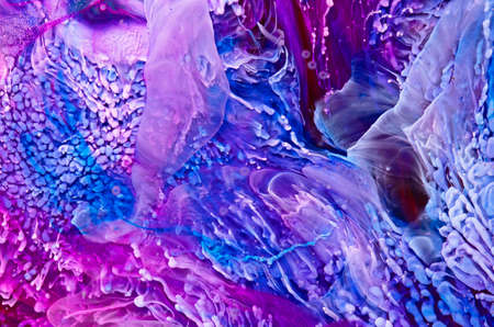 Resin art texture with blue, purple and white colors. Fluid background with splashes and swirls. Abstract frozen artwork with splatter inks. Bright pigments mixes on macrophotography pictureの写真素材