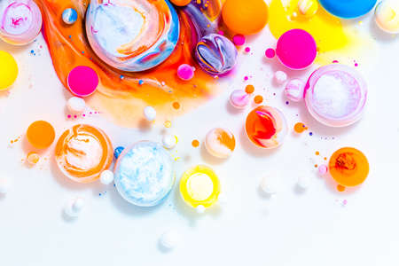 Fluid art texture. Abstract background with swirling paint effect. Liquid acrylic picture that flowing bubbles. Mixed paints for baner or wallpaper. Rainbow overflowing colorsの写真素材