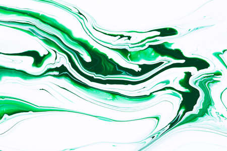 Fluid art texture. Abstract background with swirling paint effect. Liquid acrylic artwork with flows and splashes. Mixed paints for website background. Green and white overflowing colorsの写真素材