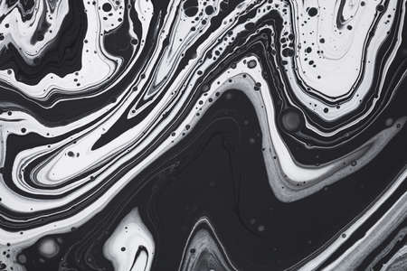 Fluid art texture. Abstract background with iridescent paint effect. Liquid acrylic picture that flows and splashes. Mixed paints for website background. Black, white and gray overflowing colorsの写真素材