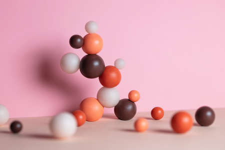 Modern composition with pastel round objects. Minimalistic geometric balls on pink and beige background. Still life with harmony and balance conceptの写真素材