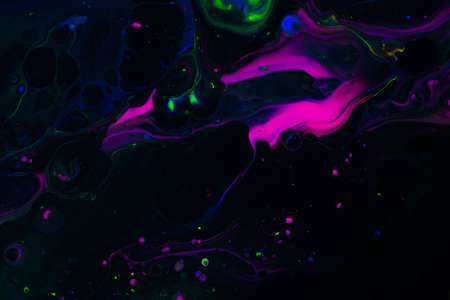 Fluid art texture. Abstract background with iridescent paint effect. Liquid acrylic artwork with artistic mixed paints. Can be used for baner or wallpaper. Black, purple and green overflowing colorsの写真素材