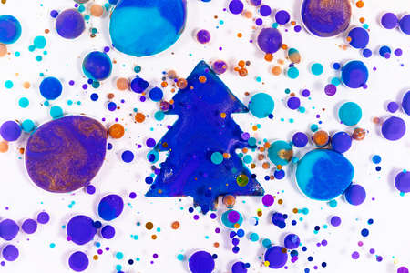 Fluid art texture. New year colorful backdrop. Liquid acrylic artwork with mixed paints and bubles. Can be used for posters or background. Christmas tree. Overflowing colors and glittersの写真素材
