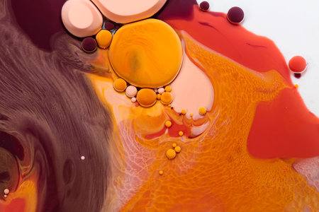 Fluid art texture. Abstract background with mixing paint effect. Liquid acrylic artwork that flowing bubbles. Mixed paints for background or poster. Yellow, brown and red overflowing colorsの写真素材