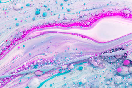 Fluid art texture. Backdrop with abstract mixing paint effect. Liquid acrylic picture that flowing bubbles. Mixed paints for interior poster. Pink, aquamarine and white overflowing colors.の写真素材