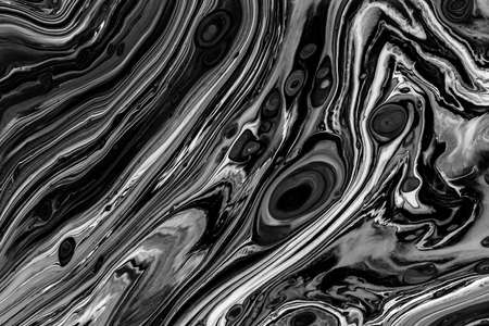 Fluid art texture. Abstract backdrop with iridescent paint effect. Liquid acrylic picture with chaotic mixed paints. Can be used for posters or wallpapers. Black and white overflowing colors.の写真素材