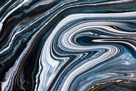 Fluid art texture. Backdrop with abstract mixing paint effect. Liquid acrylic picture with beautiful mixed paints. Can be used for interior poster. Black, navy blue and white overflowing colors.の写真素材