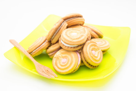 cookies on green disk with wood fork on white background