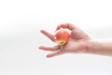 hand with apple isolate on whit backgroundの写真素材