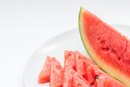 Closeup of watermelon whole and slice on white backgroundの写真素材