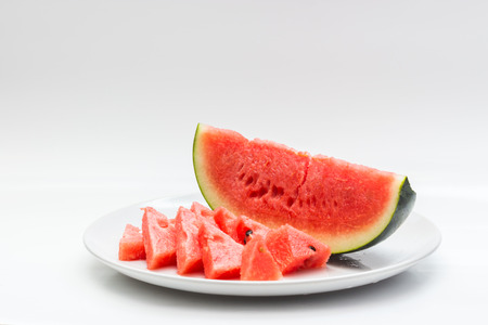 Closeup of watermelon whole and slice on white backgroundの写真素材