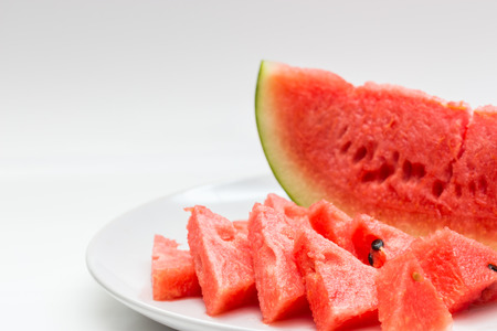 Closeup of watermelon whole and slice on white backgroundの写真素材