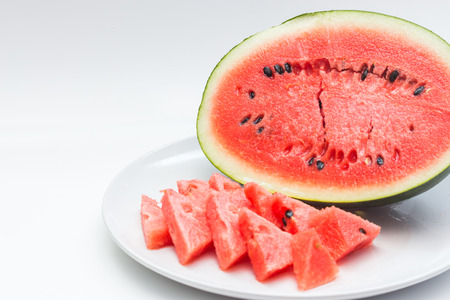 Closeup of watermelon whole and slice on white backgroundの写真素材