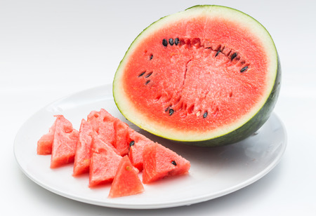 Closeup of watermelon whole and slice on white backgroundの写真素材