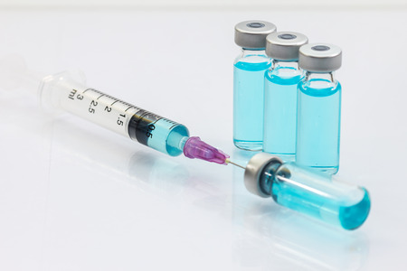 syringe sucks the vaccine from a bottleの写真素材
