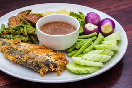 fried mackerel with shrimp paste sauce , nam phik krapi Thai food on wooden tableの写真素材
