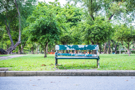 Lonely wooden bench in the parkの写真素材