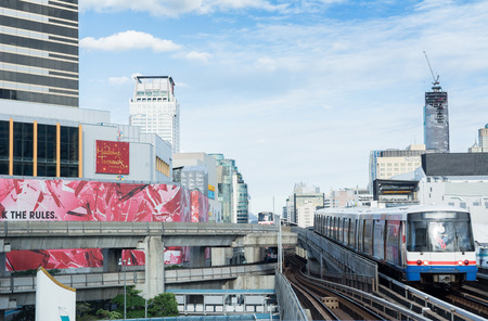 BANGKOK - Aug 22: A BTS Skytrain on elevated rails above Ratchadamri Road on Aug 22, 2015 in Bangkok, Thailand. Each train of the mass transport rail network can carry over 1,000 passengers.のeditorial素材
