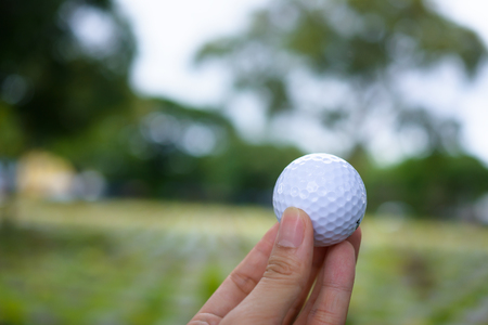 Golf ball in his handの写真素材