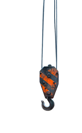 Black and orange cranes hooks hanging on steel ropes isolated on white backgroundの写真素材
