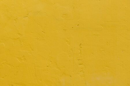 Yellow grunge cement wall, texture backgroundの写真素材