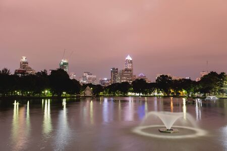 BANGKOK - Jan 3: Cityscape from Lumpini Park in the business district on jan 3, 2016 in Bangkok, Thailand. Lumpini Park is the big park in center of Bangkok covers 142 acres with 2.5 km of pathways and a large boating lakeのeditorial素材
