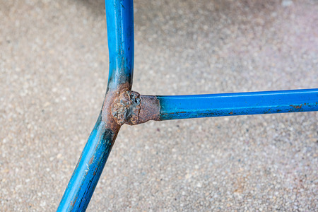Close up Weld on a blue pipe steel ironの写真素材