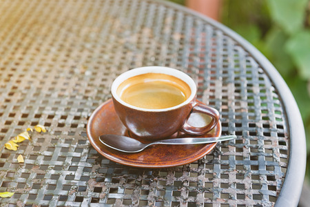 morning coffee on iron table with sunlightの写真素材