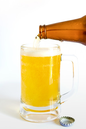 Close up of bottle of beer pouring into a glass, Cold refreshmentの写真素材