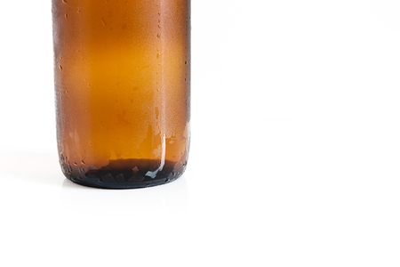 Bottle of beer with drops on a white background,Close up part of the bottleの写真素材