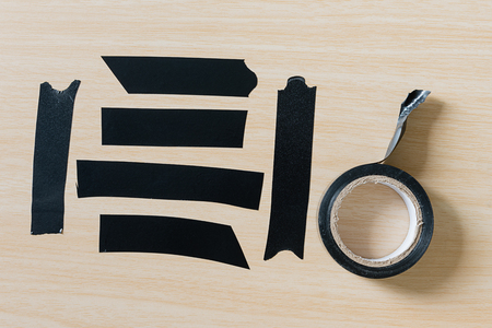 Set of different black adhesive duct tape pieces on wooden backgroundの写真素材