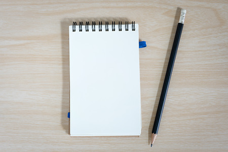 notebook with a pencil on wooden backgroundの写真素材